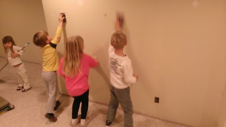 The kids insisted on helping prep the walls.